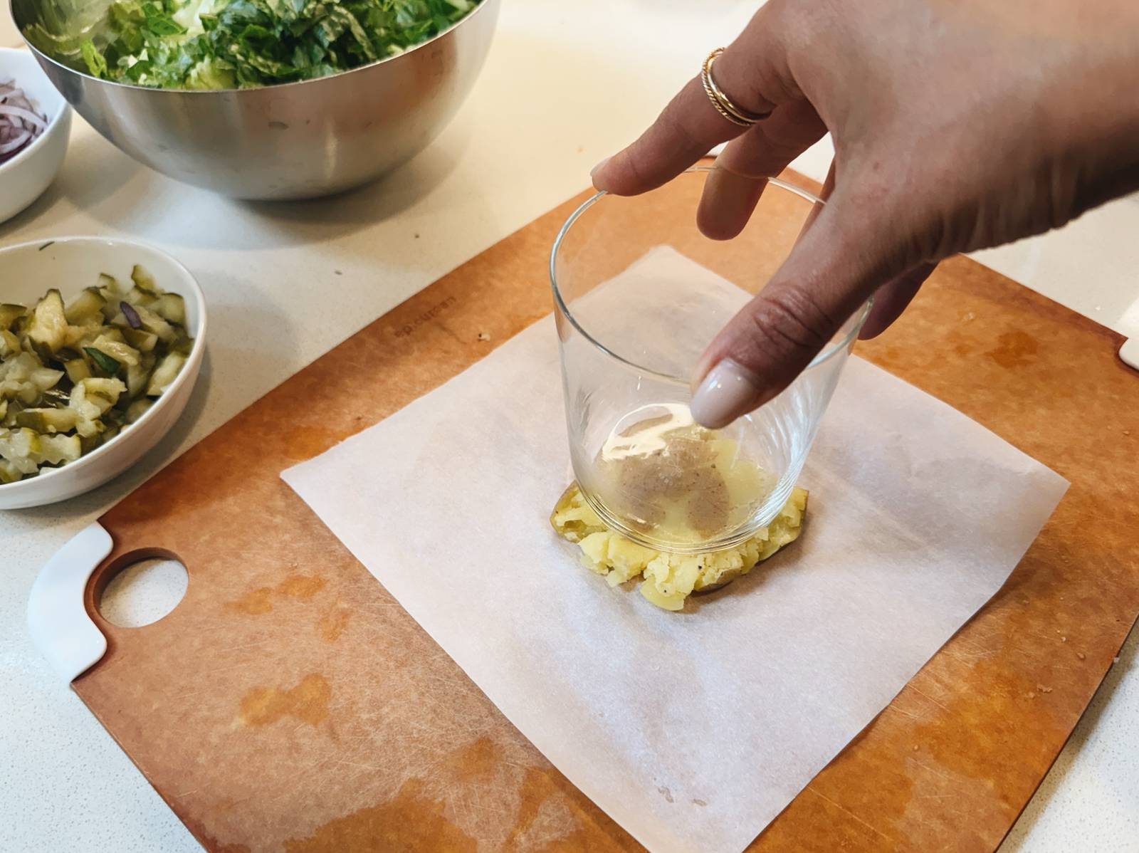 Smashing potato with the back of a drinking glass.