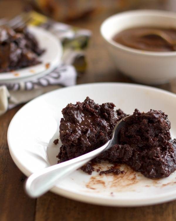 Chocolate caramel cake on a white plate.