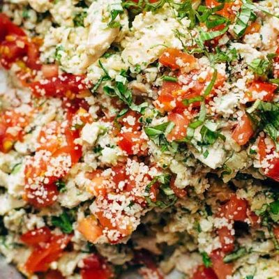 Healthy Chicken Salad in a serving bowl with wooden spoon.