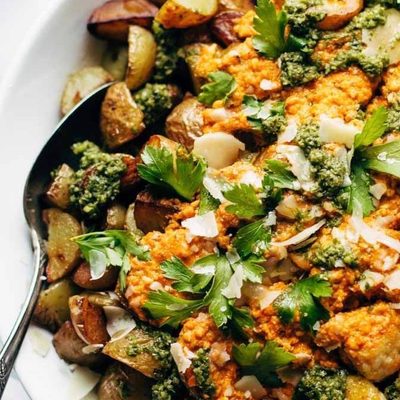 Mini Chicken Meatballs with roasted potatoes and romesco sauce in a bowl.