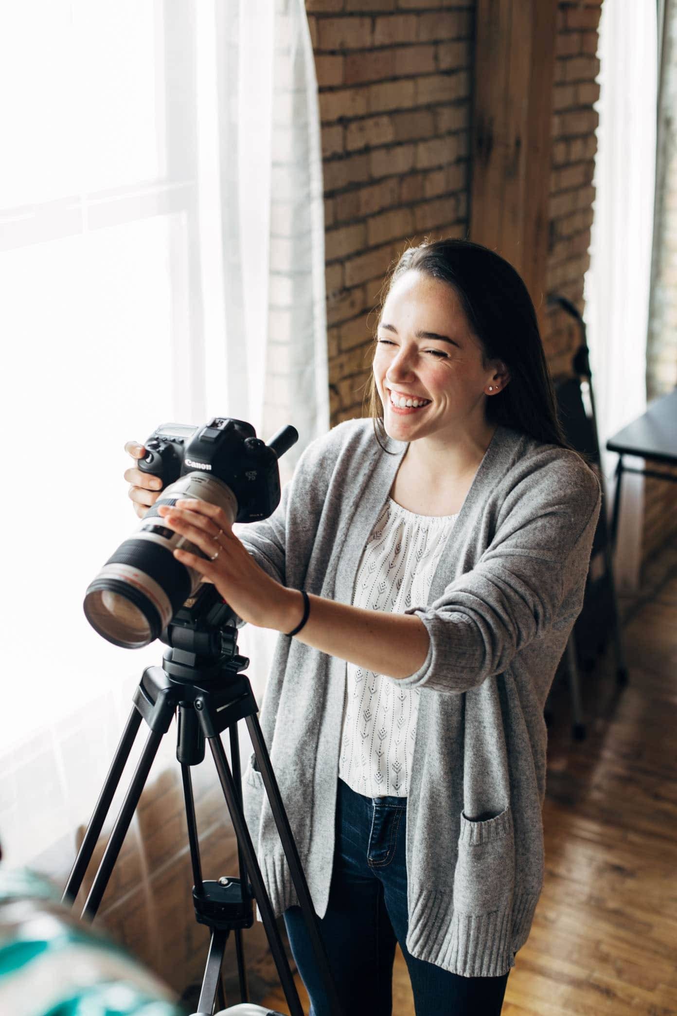 Woman taking a video with a camera.