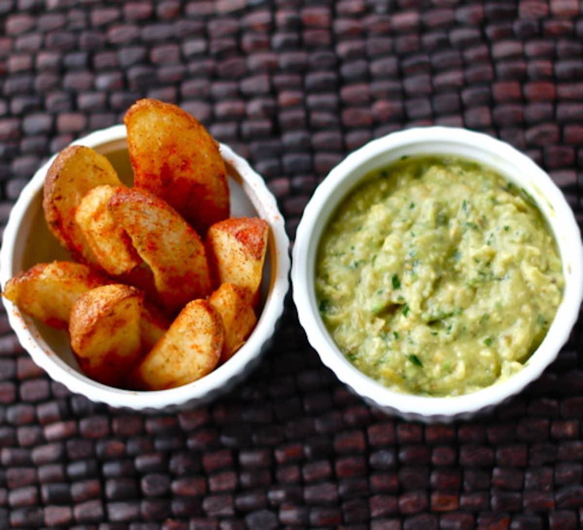 Avocado tomatillo dip with potato wedges.
