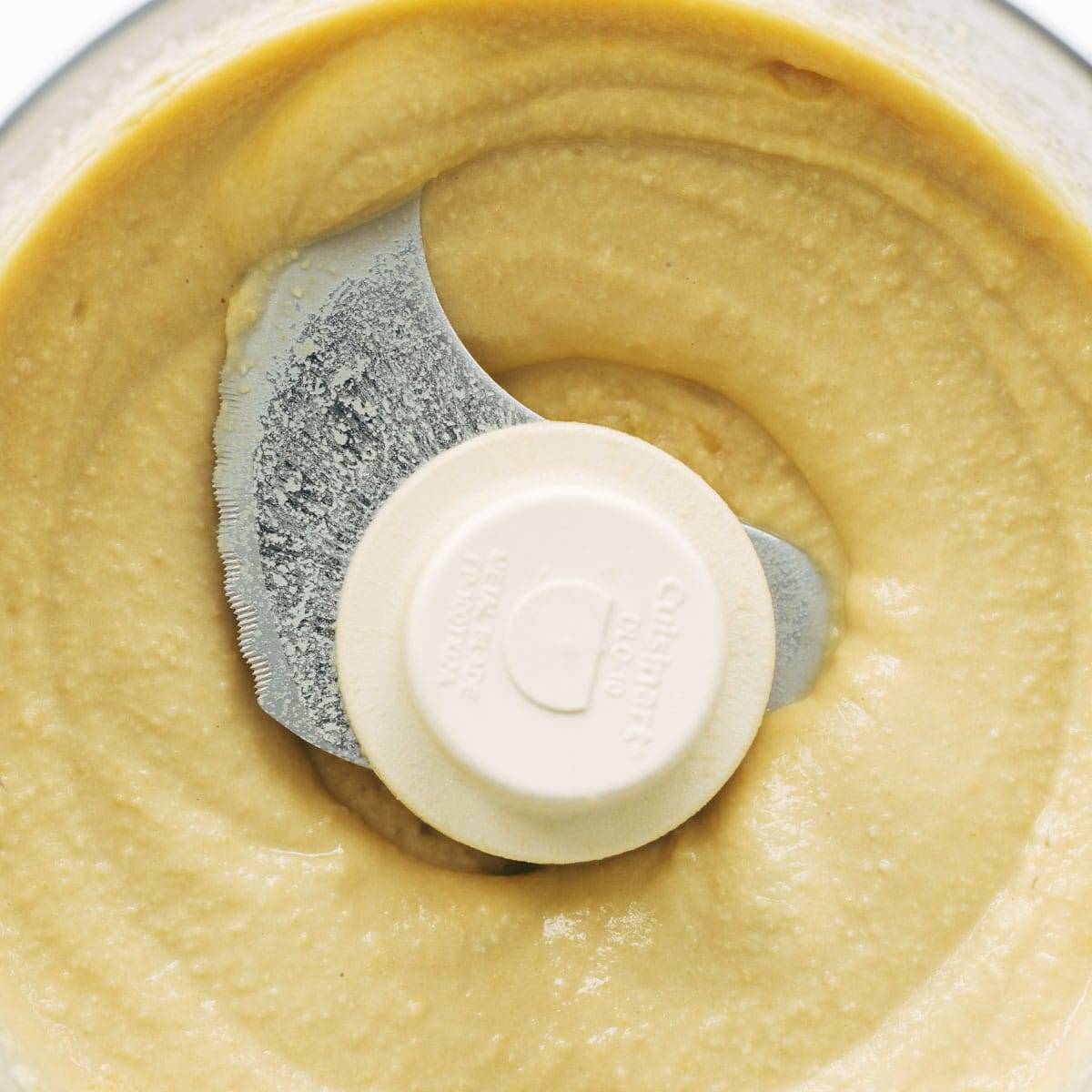 Hummus blended in food processor.