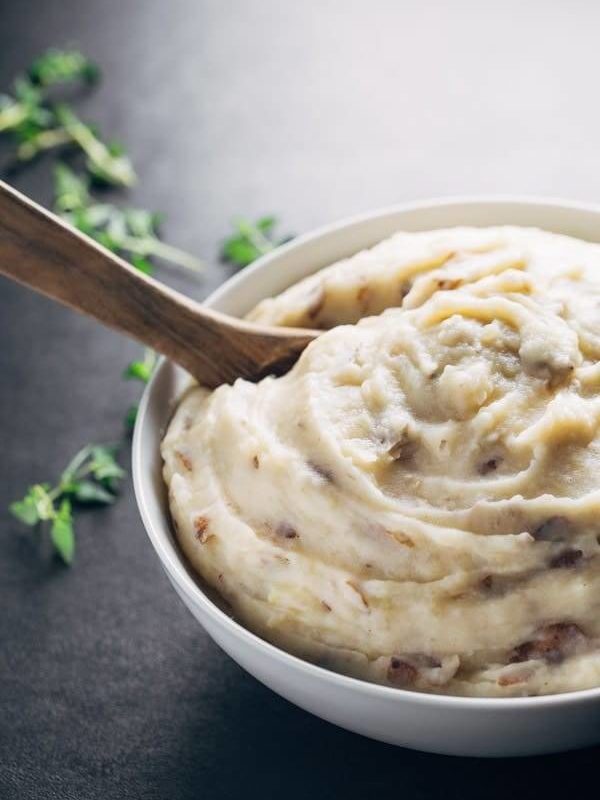 Easiest Garlic Mashed Potatoes - made entirely in the bowl of a slow cooker for easy prep and clean up! And that roasted garlic flavor - YUM.