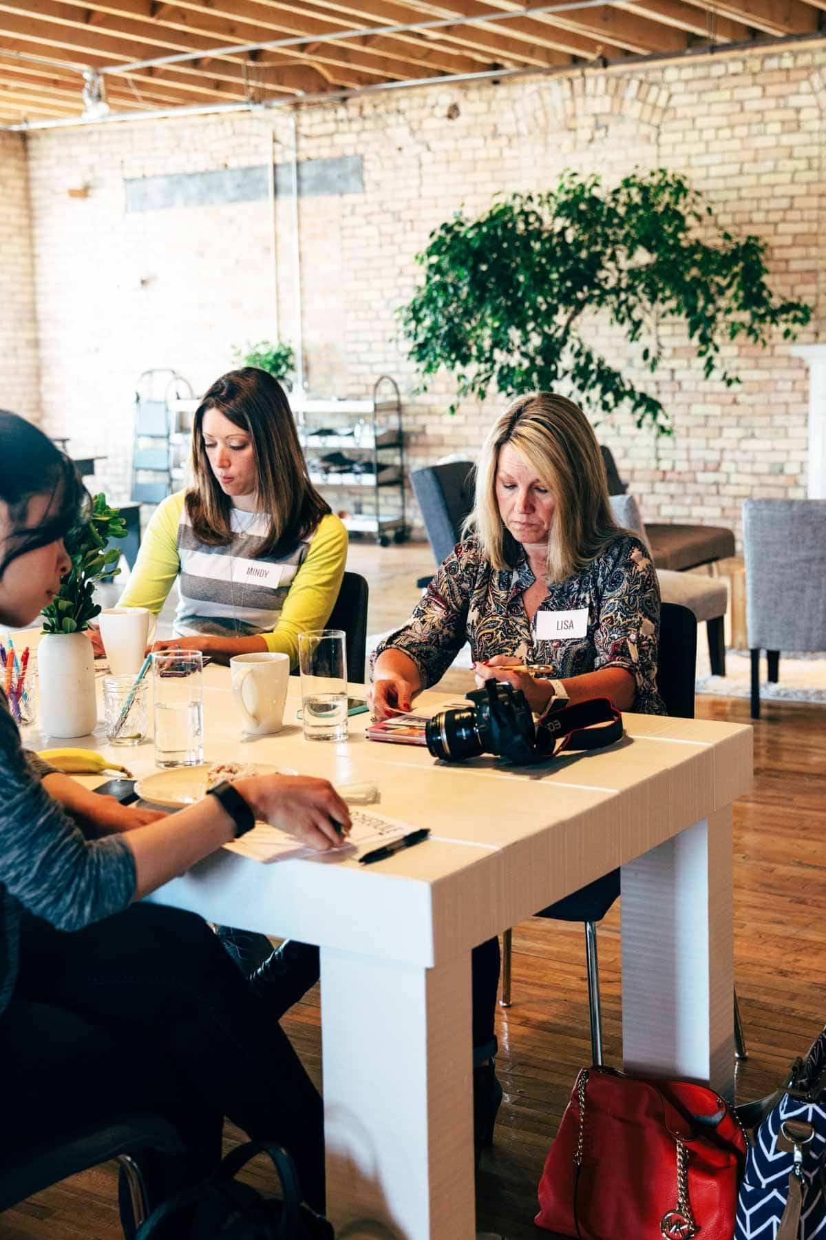 Women sitting at a table working.